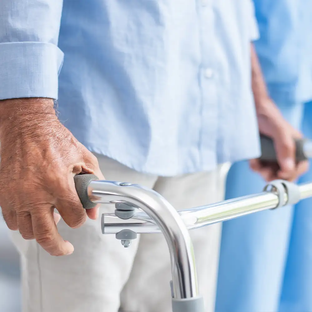Ein Patient mit Amyotropher Lateralsklerose wird von einem Physiotherapeuten behandelt.